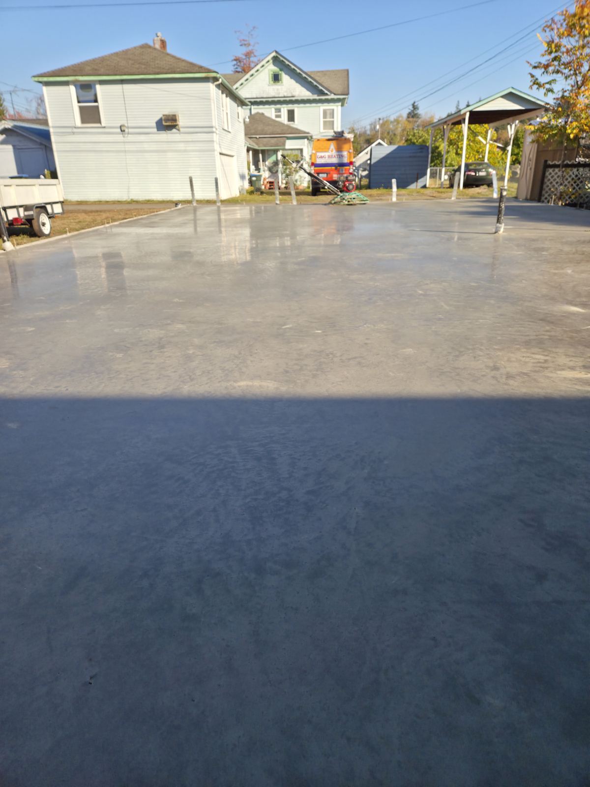Freshly poured concrete slab beside a home