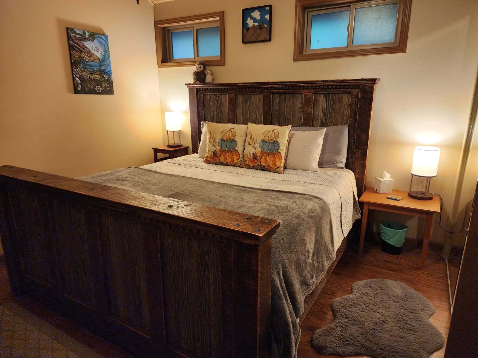 Freshly made bed with a rustic headboard