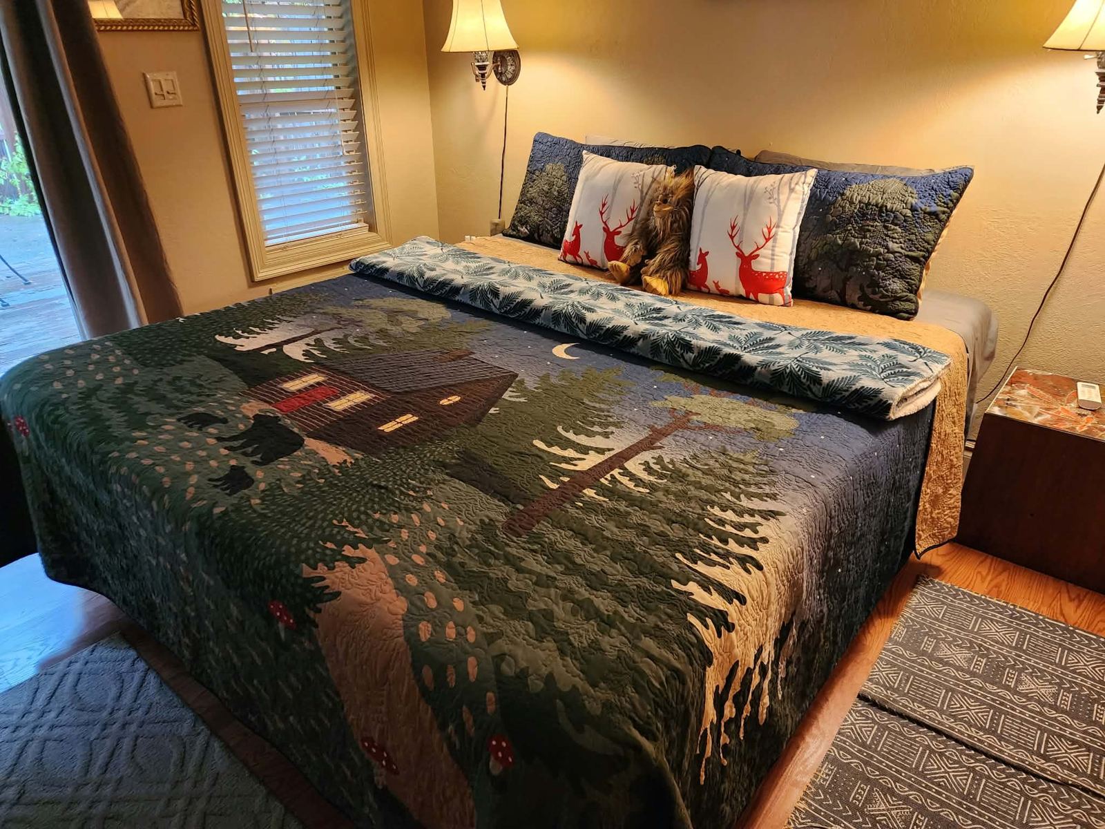 Guest-ready bedroom with a forest quilt